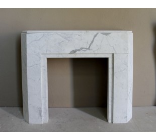 Beautiful antique Art Deco-style fireplace mantel carved in White veined Carrara marble.