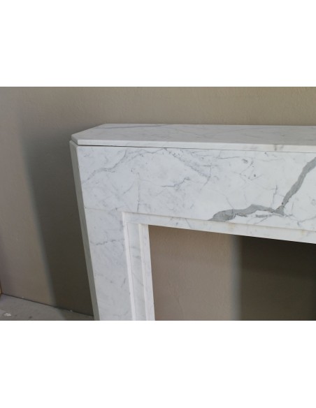 Beautiful antique Art Deco-style fireplace mantel carved in White veined Carrara marble.
