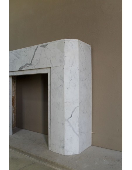 Beautiful antique Art Deco-style fireplace mantel carved in White veined Carrara marble.