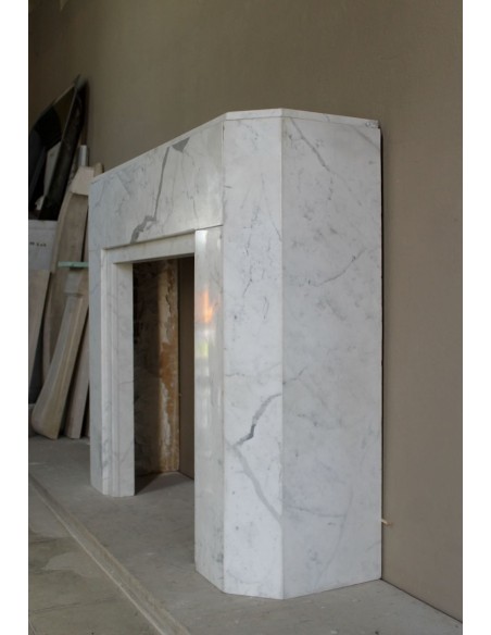 Beautiful antique Art Deco-style fireplace mantel carved in White veined Carrara marble.