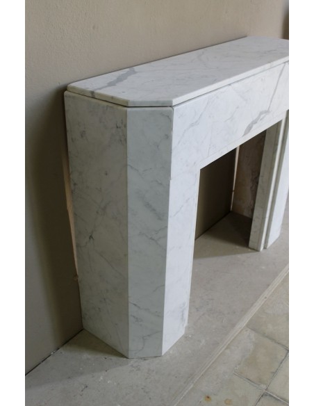Beautiful antique Art Deco-style fireplace mantel carved in White veined Carrara marble.