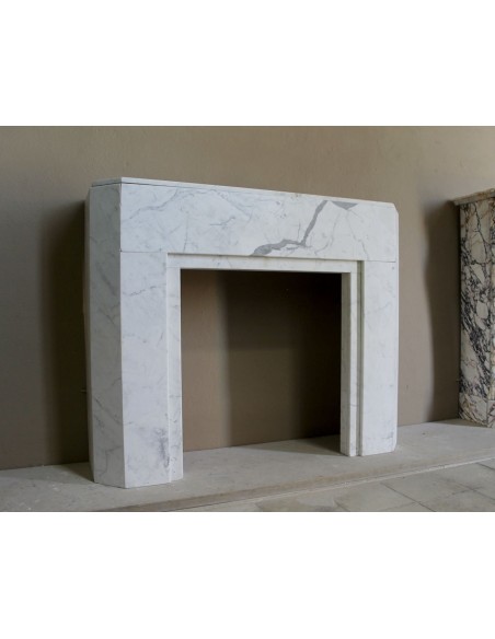 Beautiful antique Art Deco-style fireplace mantel carved in White veined Carrara marble.