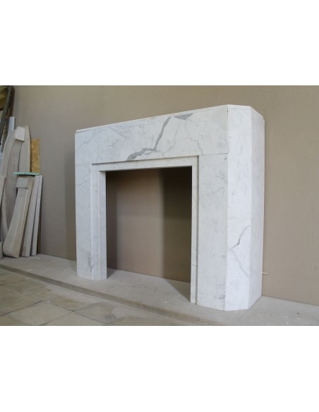 Beautiful antique Art Deco-style fireplace mantel carved in White veined Carrara marble.