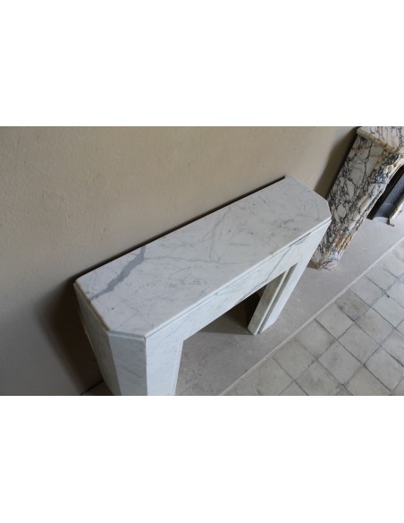 Beautiful antique Art Deco-style fireplace mantel carved in White veined Carrara marble.