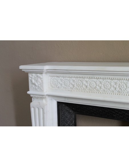 Exceptionally small and refined Neoclassical “Macaron” antique fireplace mantel in pristine Statuario white marble.