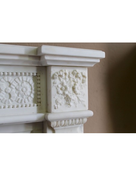 Exceptionally small and refined Neoclassical “Macaron” antique fireplace mantel in pristine Statuario white marble.