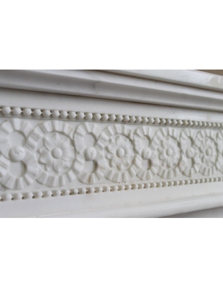 Exceptionally small and refined Neoclassical “Macaron” antique fireplace mantel in pristine Statuario white marble.