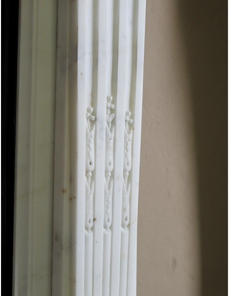 Exceptionally small and refined Neoclassical “Macaron” antique fireplace mantel in pristine Statuario white marble.
