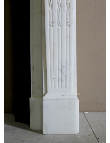 Exceptionally small and refined Neoclassical “Macaron” antique fireplace mantel in pristine Statuario white marble.