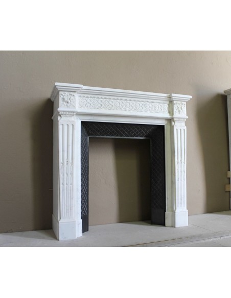 Exceptionally small and refined Neoclassical “Macaron” antique fireplace mantel in pristine Statuario white marble.