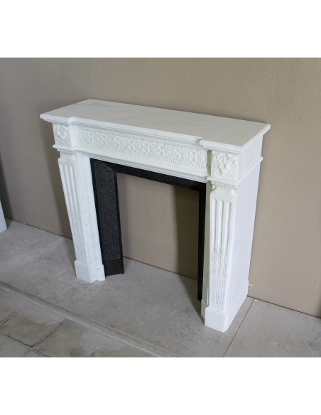 Exceptionally small and refined Neoclassical “Macaron” antique fireplace mantel in pristine Statuario white marble.