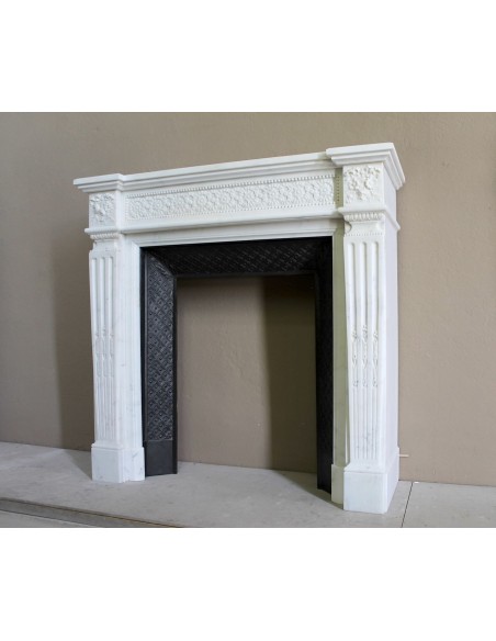 Exceptionally small and refined Neoclassical “Macaron” antique fireplace mantel in pristine Statuario white marble.