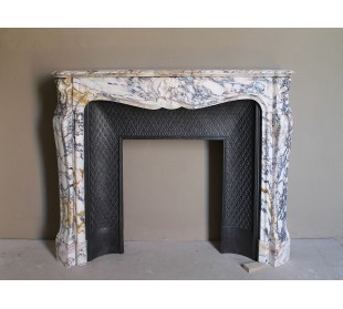 Antique Louis XV fireplace in Calacatta Gold marble with striking gold, violet and pink veining, with original cast-iron insert.