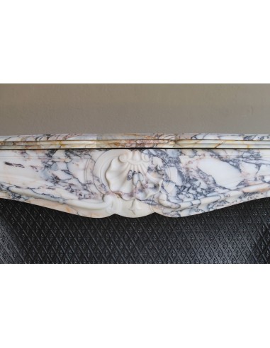 Antique Louis XV fireplace in Calacatta Gold marble with striking gold, violet and pink veining, with original cast-iron insert.