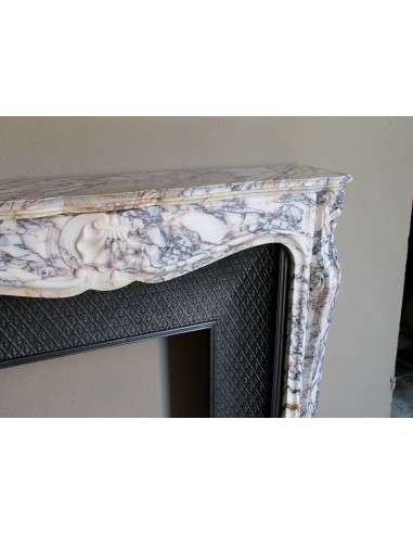 Antique Louis XV fireplace in Calacatta Gold marble with striking gold, violet and pink veining, with original cast-iron insert.