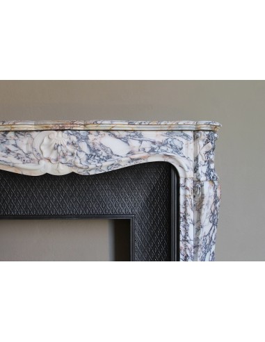 Antique Louis XV fireplace in Calacatta Gold marble with striking gold, violet and pink veining, with original cast-iron insert.