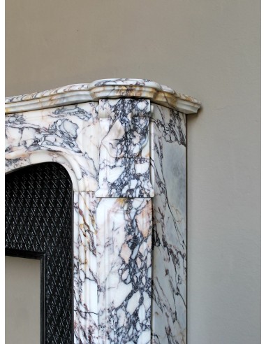 Antique Louis XV fireplace in Calacatta Gold marble with striking gold, violet and pink veining, with original cast-iron insert.