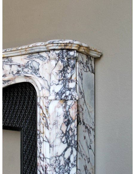 Antique Louis XV fireplace in Calacatta Gold marble with striking gold, violet and pink veining, with original cast-iron insert.
