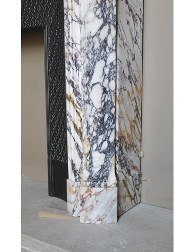 Antique Louis XV fireplace in Calacatta Gold marble with striking gold, violet and pink veining, with original cast-iron insert.