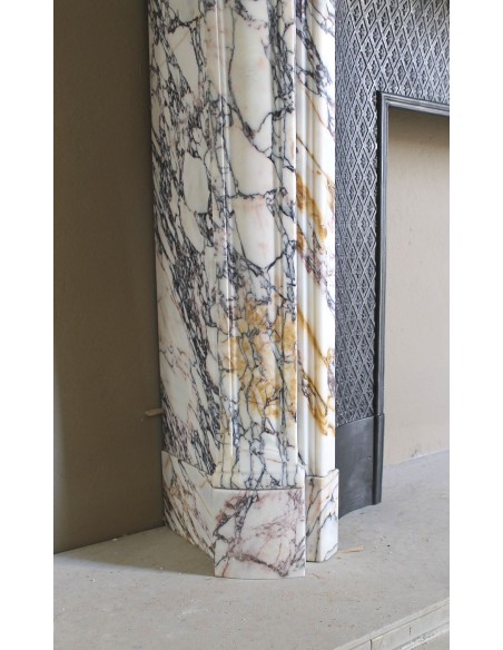 Antique Louis XV fireplace in Calacatta Gold marble with striking gold, violet and pink veining, with original cast-iron insert.