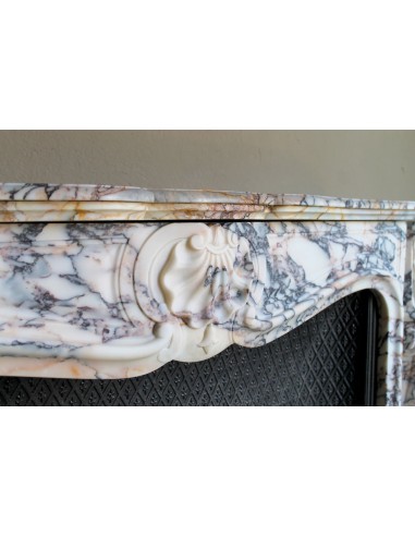 Antique Louis XV fireplace in Calacatta Gold marble with striking gold, violet and pink veining, with original cast-iron insert.