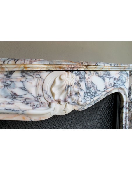 Antique Louis XV fireplace in Calacatta Gold marble with striking gold, violet and pink veining, with original cast-iron insert.