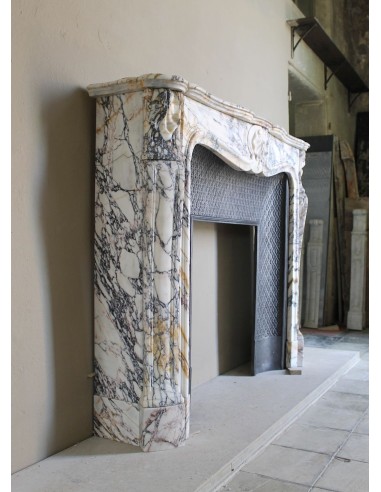 Antique Louis XV fireplace in Calacatta Gold marble with striking gold, violet and pink veining, with original cast-iron insert.