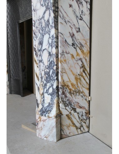 Antique Louis XV fireplace in Calacatta Gold marble with striking gold, violet and pink veining, with original cast-iron insert.