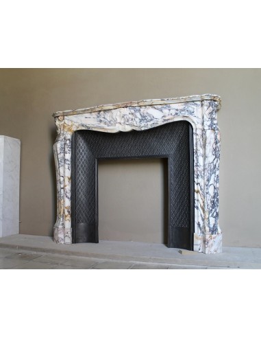 Antique Louis XV fireplace in Calacatta Gold marble with striking gold, violet and pink veining, with original cast-iron insert.