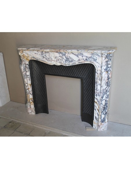 Antique Louis XV fireplace in Calacatta Gold marble with striking gold, violet and pink veining, with original cast-iron insert.
