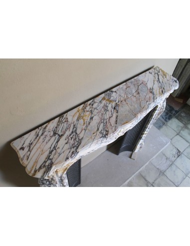 Antique Louis XV fireplace in Calacatta Gold marble with striking gold, violet and pink veining, with original cast-iron insert.