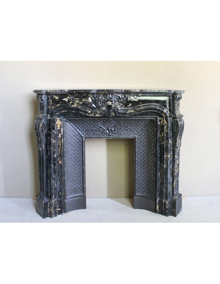 Exceptional Louis XV "Heart" antique fireplace mantel in Black Portoro Gold marble, complete with decorative cast-iron insert.