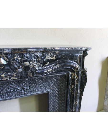 Exceptional Louis XV "Heart" antique fireplace mantel in Black Portoro Gold marble, complete with decorative cast-iron insert.