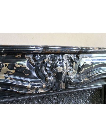 Exceptional Louis XV "Heart" antique fireplace mantel in Black Portoro Gold marble, complete with decorative cast-iron insert.