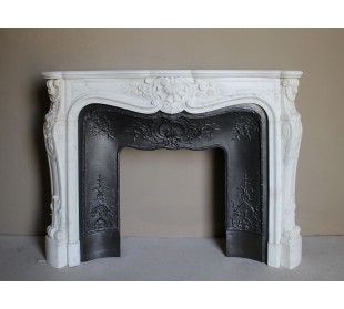 Impressive Baroque antique fireplace in Statuary White marble, featuring elegant floral carvings, and a cast-iron insert.