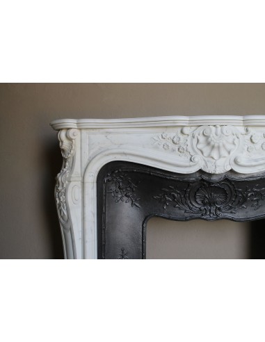 Impressive Baroque antique fireplace in Statuary White marble, featuring elegant floral carvings, and a cast-iron insert.