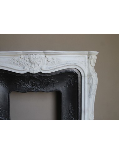 Impressive Baroque antique fireplace in Statuary White marble, featuring elegant floral carvings, and a cast-iron insert.