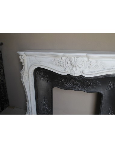 Impressive Baroque antique fireplace in Statuary White marble, featuring elegant floral carvings, and a cast-iron insert.