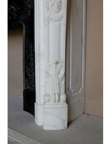 Impressive Baroque antique fireplace in Statuary White marble, featuring elegant floral carvings, and a cast-iron insert.