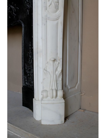 Impressive Baroque antique fireplace in Statuary White marble, featuring elegant floral carvings, and a cast-iron insert.