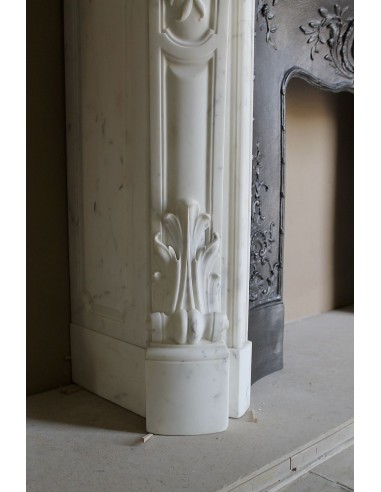 Impressive Baroque antique fireplace in Statuary White marble, featuring elegant floral carvings, and a cast-iron insert.