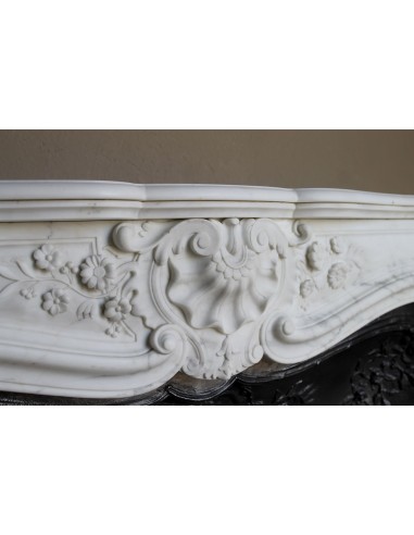 Impressive Baroque antique fireplace in Statuary White marble, featuring elegant floral carvings, and a cast-iron insert.