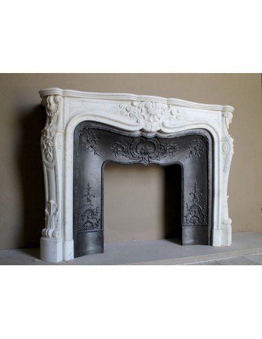 Impressive Baroque antique fireplace in Statuary White marble, featuring elegant floral carvings, and a cast-iron insert.