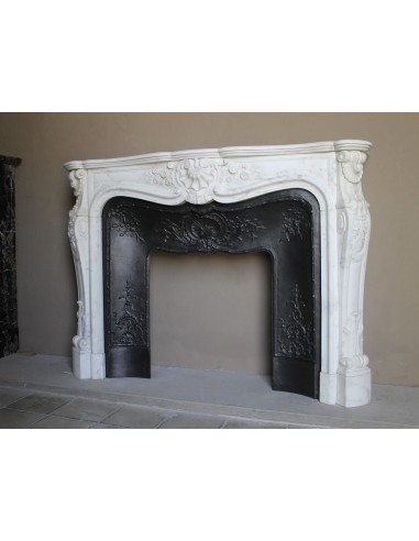 Impressive Baroque antique fireplace in Statuary White marble, featuring elegant floral carvings, and a cast-iron insert.