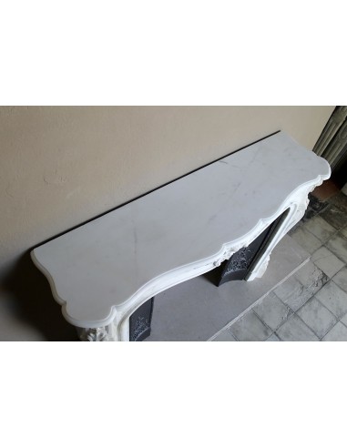 Impressive Baroque antique fireplace in Statuary White marble, featuring elegant floral carvings, and a cast-iron insert.