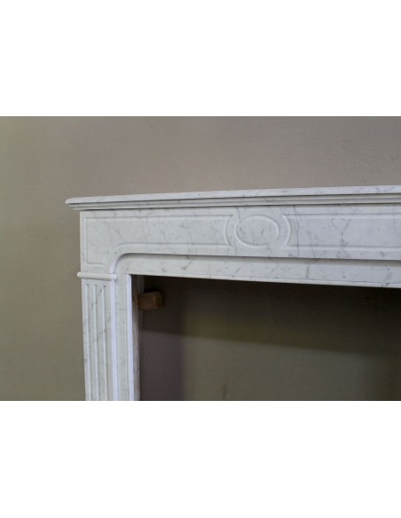 Antique Neoclassical fireplace mantel in White Carrara marble, with clean, elegant lines, available at a discounted price.