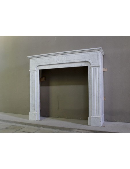 Antique Neoclassical fireplace mantel in White Carrara marble, with clean, elegant lines, available at a discounted price.