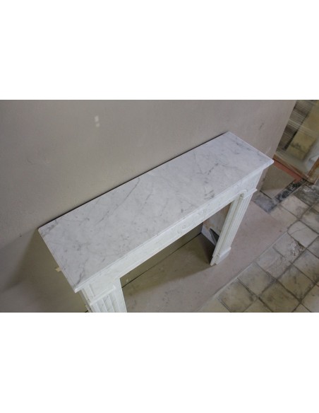 Antique Neoclassical fireplace mantel in White Carrara marble, with clean, elegant lines, available at a discounted price.