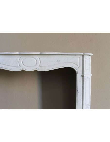 Antique Louis XV "Pompadour Plat" fireplace mantel in White Carrara marble, an iconic example of the classic Parisian style.
