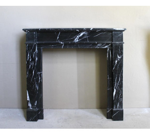 Minimalist Louis XVI fireplace mantel in Black Marquinia marble, with a refined Neoclassical architecture and white veining.